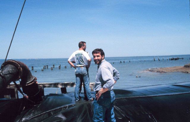 Lee Crockett, formerly of NOAA, stands in front of a geotube being filled. Picture
