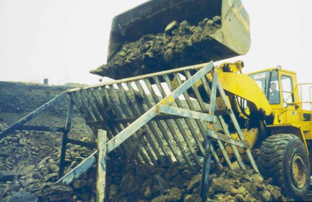 Sifting rocks to ensure that appropriate size cobble was used in the creation of the reefs placed in the Bay. Picture