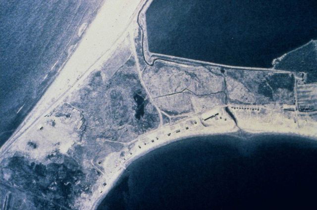Shows the marsh after construction of the road divided the marsh. Picture