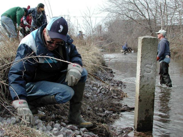 Volunteers at the town boundary work to place habitat structure. Picture