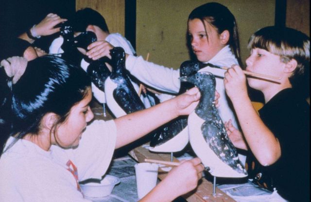 Local schoolchildren from the Half Moon Bay area repaint the decoys that were used to attract common murres back to Devil Slide Rock. Picture