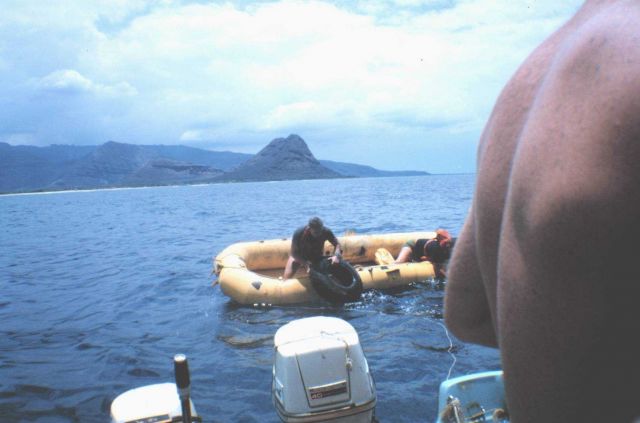 Navy divers assisting in the placement of used tires as an alternate reef material on the artificial reef site at Pokai Bay, Oahu Picture
