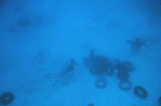 Tires being placed in an array to determine their effectiveness as habitat for fish. Picture