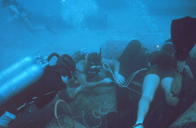 Tires being placed in an array to determine their effectiveness as habitat for fish. Picture