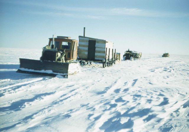 Caterpillar train towing wanigans and supplies to remote camp Picture