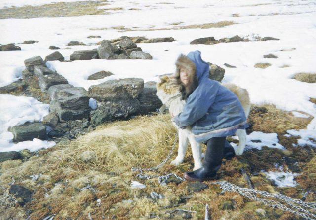 An Eskimo with a sled dog. Picture