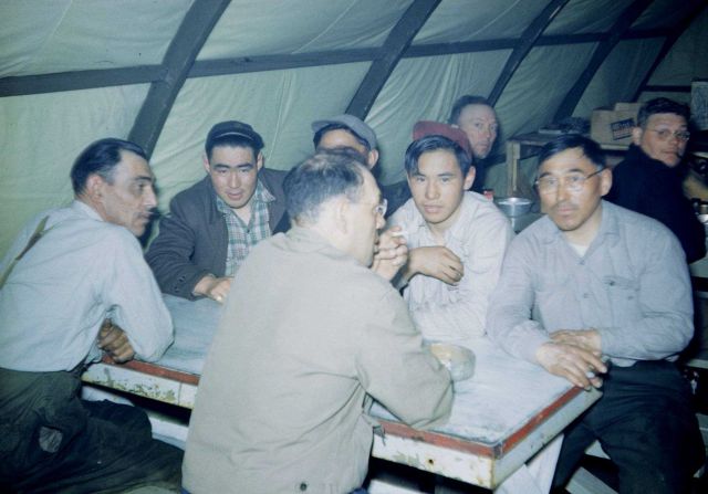 Hanging out in the mess hall quonset hut after a day's work. Picture