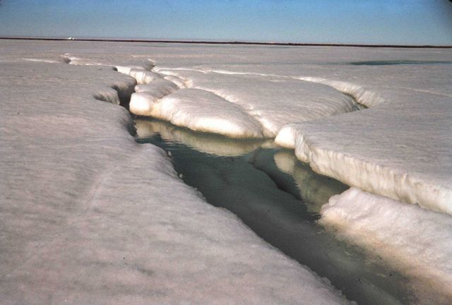 The first sign of the spring melt - a stream is seen flowing on the ice Picture