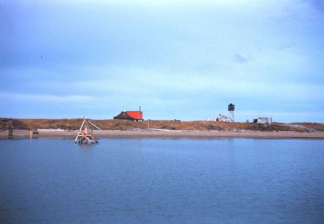 Tide gage, hydrographic signal, and shore camp Older buildings are from ca Picture