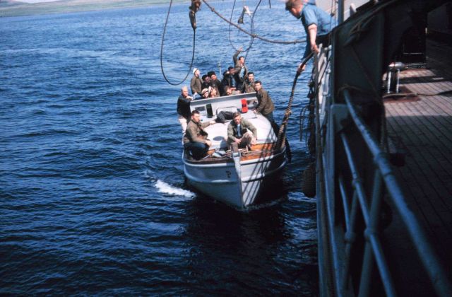 Work parties returning to the PATHFINDER from a day ashore. Picture