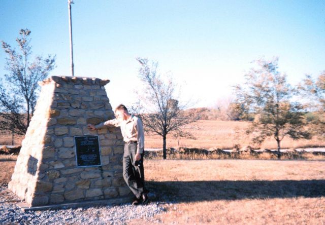 Harley Nygren reading marker indicating geographical center of United States Picture