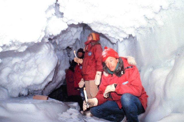 Using candles for lighting while exploring ice cave Picture