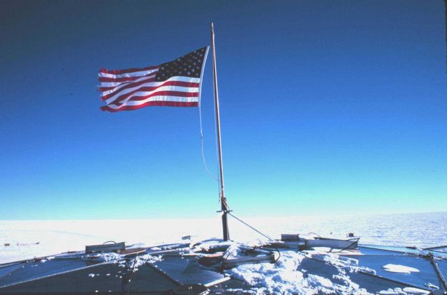 The United States Flag at the top of the South Pole Station geodesic dome. Picture