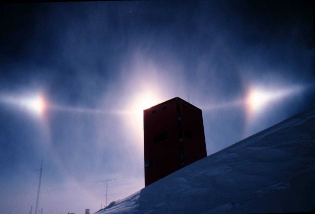 Small halo, sun dogs, and arc of much larger halo nearly bisecting smaller halo. Picture