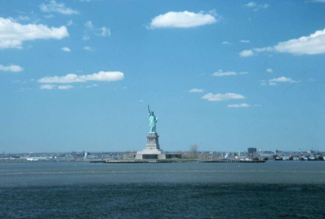 The Statue of Liberty, New York Harbor, with fair weather cumulus Picture