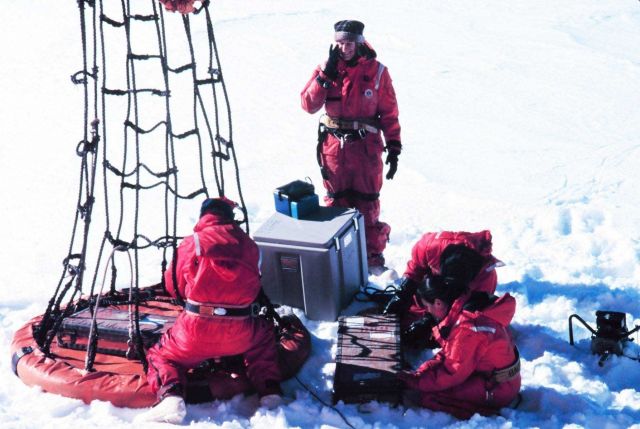 Personnel basket putting people out on the ice for sample collection from the NATHANIEL B Picture