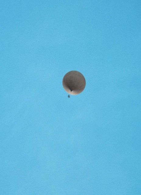 Meteorological balloon with instrument package swinging below at McMurdo Station. Picture