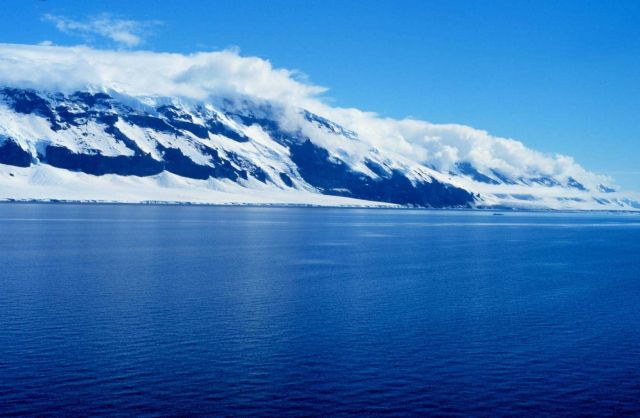 Coulman Island with clouds forming at the top edge as cold air spills down off the island top. Picture