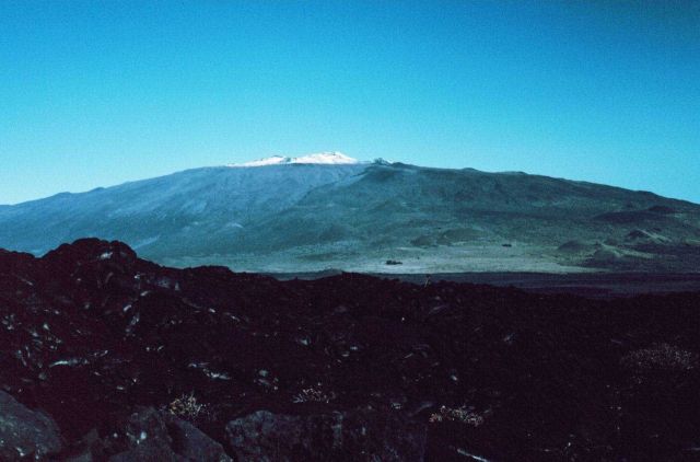 A view of snow-capped Mauna Kea as seen over an aa lava flow from Mauna Loa. Picture