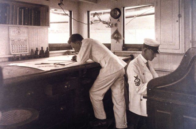 Working on a hydrographic survey smooth sheet on board the C&GS Ship BACHE in July 1916. Picture
