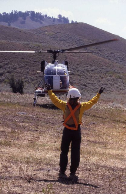 Helitack signalman signing for helicopter take off at Lamar Helibase Picture