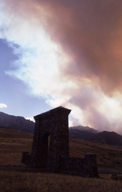 Roosevelt Arch with smoke behind it, looking north Picture
