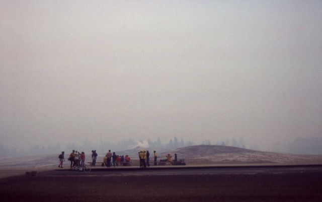 Group of employees at Old Faithful Geyser boardwalk with dense smoke Picture