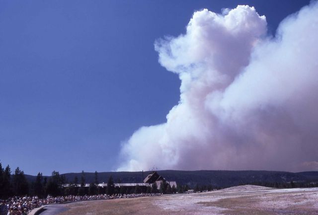 Smoke plume from Madison Plateau with Old Faithful Inn & crowd in foreground Picture