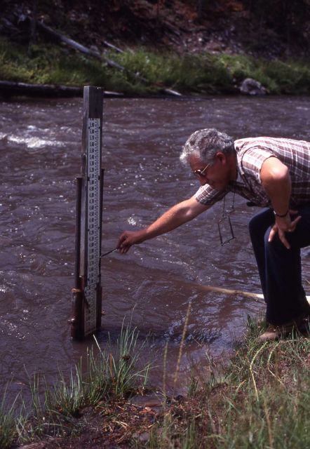 USGS Geologist pointing to high water mark at gauging station in Gibbon Canyon - Erosion/Geology Picture