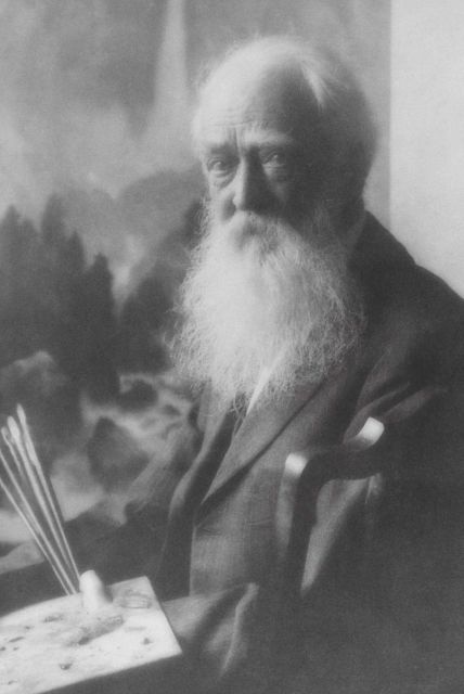 Thomas Moran, age 85, posing in front of painting Picture