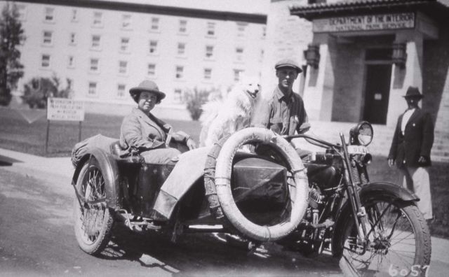 Man on motorcycle, woman in side car with dog, honeymoon Picture