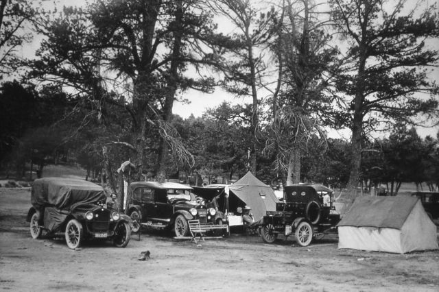 Visitors beside tents & model A's Picture