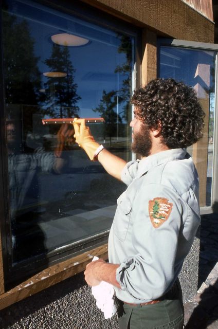 Maintenance worker washing windows at Old Faithful Visitor Center Picture