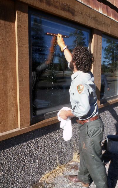 Maintenance worker washing windows at Old Faithful Visitor Center Picture