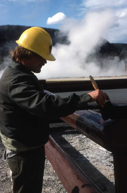 Maintenance worker painting railings Picture