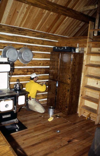 Maintenance worker finishing the cupboards at the Sportsman Lake cabin Picture