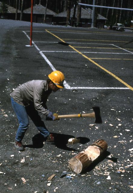 Youth Conservation Corp worker making bumper logs (chopping in grooves) Picture