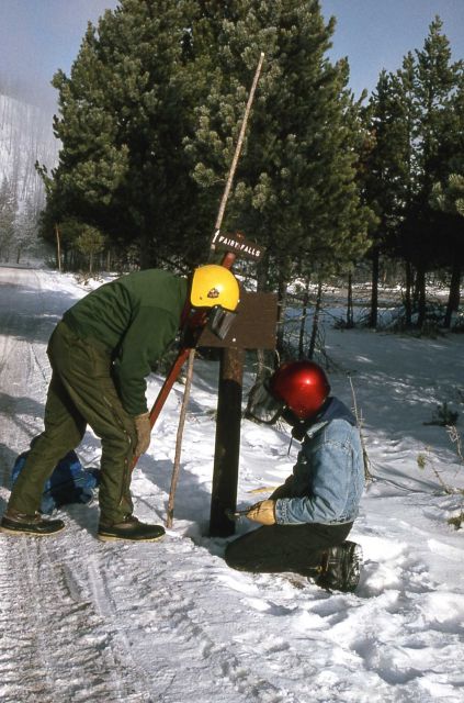 National Park Service employees replacing Fairy Falls trail sign in the winter Picture
