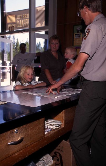 Ranger Jeremy Peterson with Junior Ranger at Canyon Visitor Center Picture