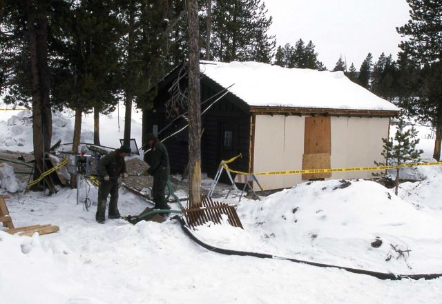 Maintenance workers installing equipment at the Old Faithful l ift station near the lower Yellowstone Park Service Station Picture