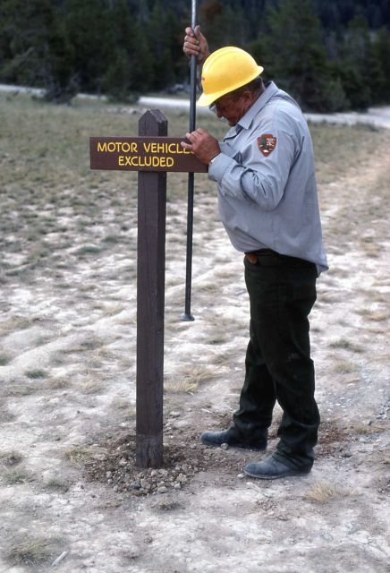 Maintenance worker installing sign Picture