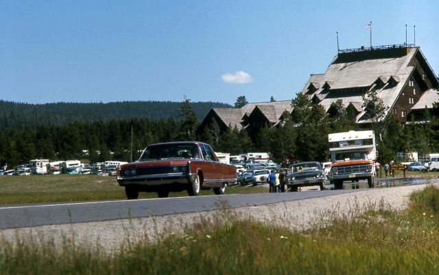 Traffic on the old road in the Old Faithful area with Old Faithful Inn in the background Picture