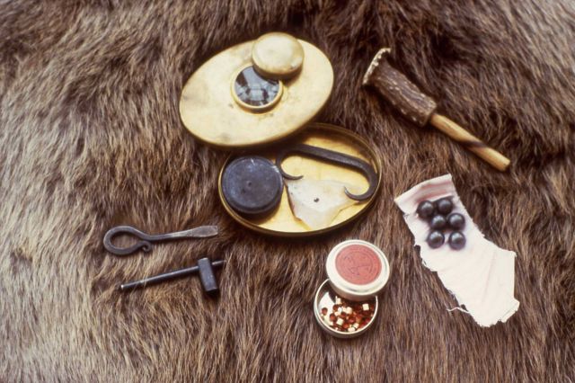 Possibles bag or hunters bag contents: l-r/top-bottom - screwdriver/turn key, nipple wrench, Hudson Bay brass tobacco box with burning glass, inside - Picture