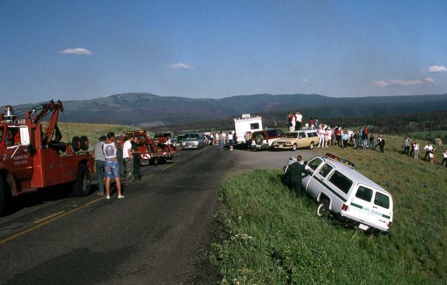 YPSS (Yellowstone Park Service Stations) tow truck pulling a patrol car back onto the road near Antelope Creek on the Dunraven Pass Road Picture