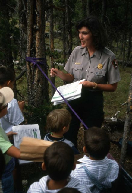Interpretive Ranger Susan Willsie signing Junior Ranger activity paper Picture