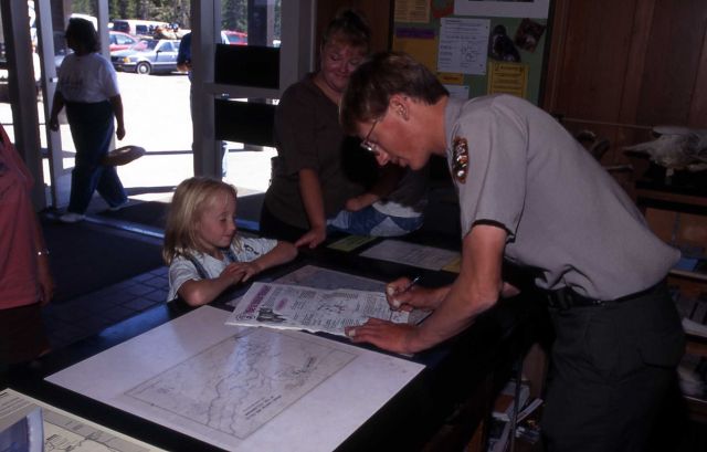 Jeremy Peterson with Junior Ranger at Canyon Visitor Center Picture