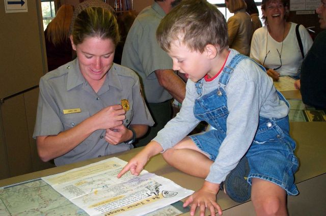 Interpretive Ranger helping Junior Ranger at Albright Visitor Center in Mammoth Hot Springs Picture