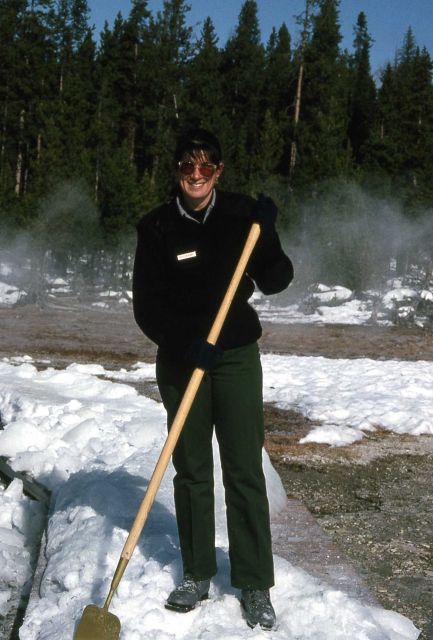 Interpretive Ranger Holly McKinney chopping ice off of the boardwalk at Old Faithful Picture