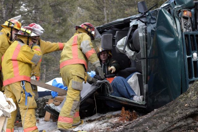Fire crew extricating a person from a vehicle after an accident Picture