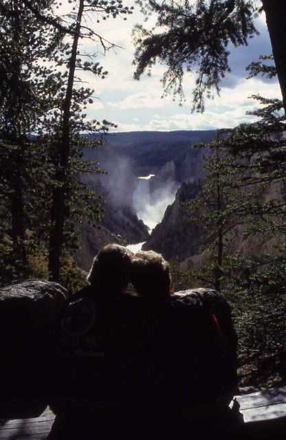 Couple sitting at Artist Point with Lower Falls in the background Picture
